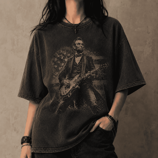 Person wearing a black t-shirt with a graphic of a historical figure playing a guitar against a plain background