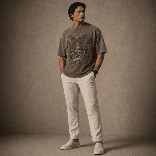 Man wearing a graphic t-shirt and white pants against a textured brown background