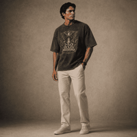 Man wearing a USA 250th Anniversary Shirt graphic t-shirt and beige pants against a textured brown background