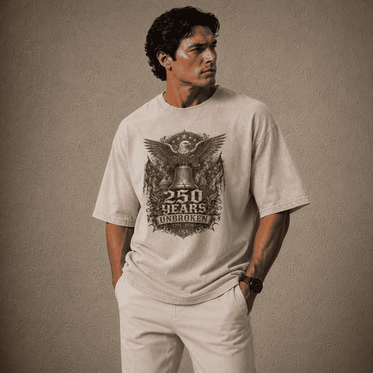 Man wearing a USA 250th Anniversary Shirt Gray t-shirt with a graphic design on a beige background