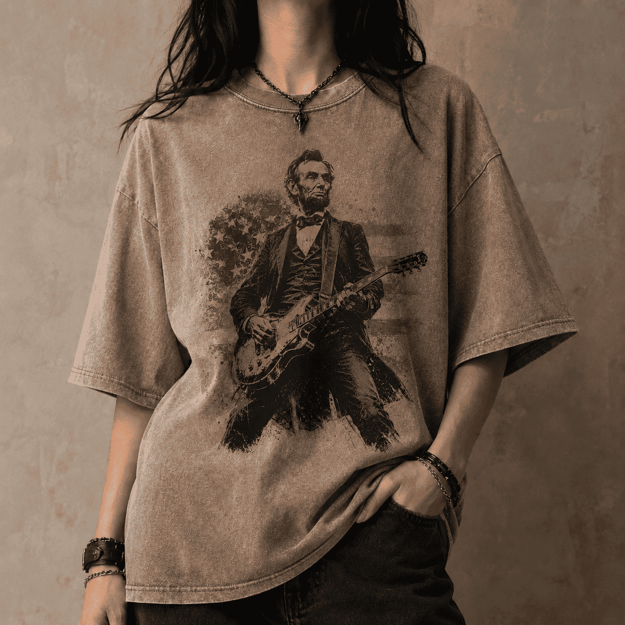 Person wearing a t-shirt with a graphic of Abraham Lincoln playing a guitar against a concrete wall.