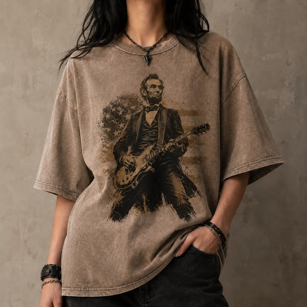 Person wearing a t-shirt with a graphic of Abraham Lincoln playing a guitar against a plain background
