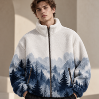 A man wearing a sherpa fleece zip-up jacket with a blue and white mountain pine forest pattern, standing in a warm, sunlit architectural setting.