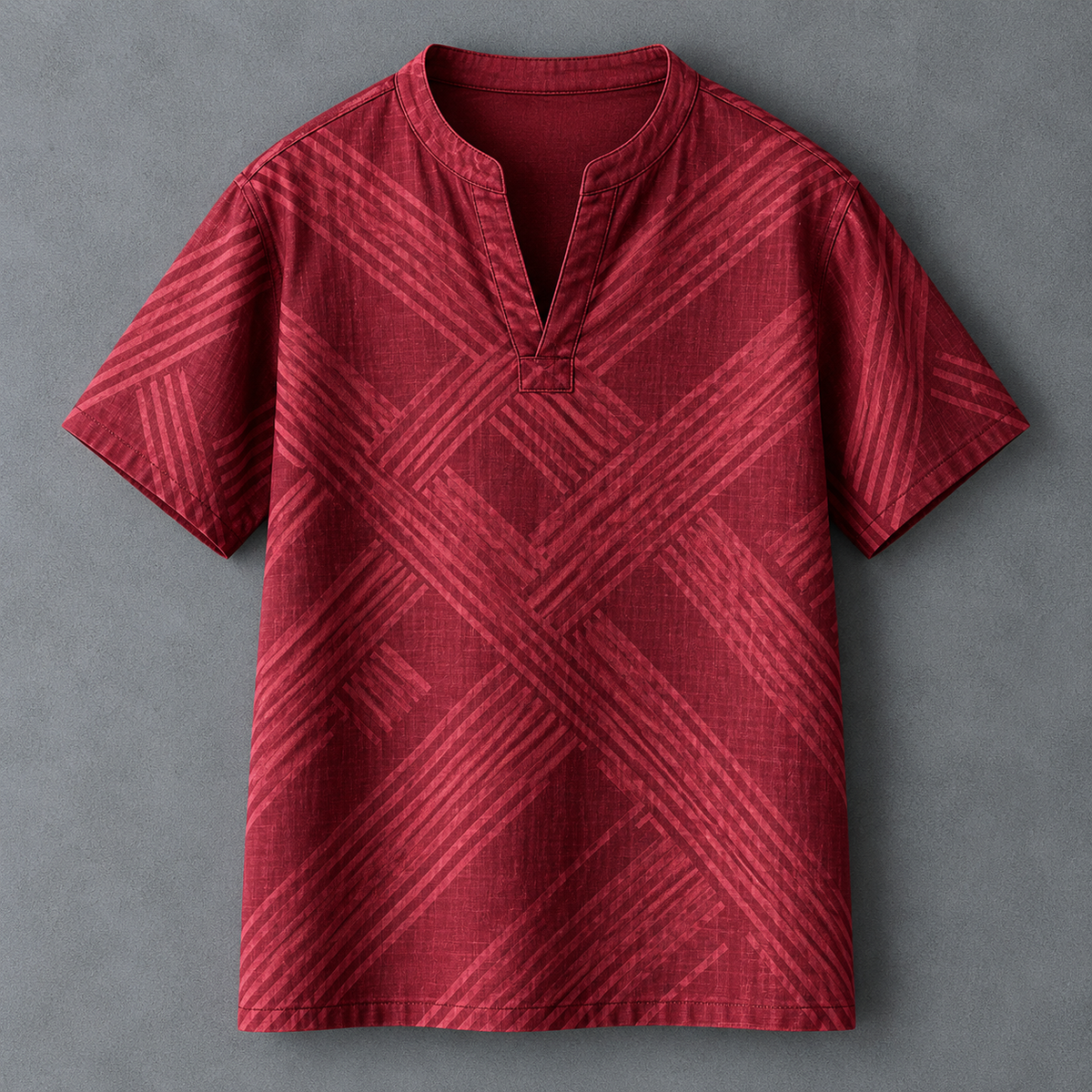 A red short-sleeve men's t-shirt with a textured geometric diagonal stripe pattern, featuring a split mandarin collar and a button placket, laid flat on a gray background.