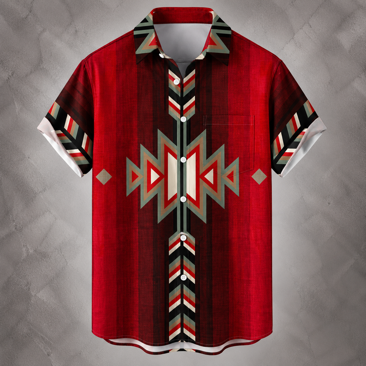 A short-sleeve button-up shirt with a bold Southwestern geometric pattern in red, black, white, and gray, displayed against a textured gray background.