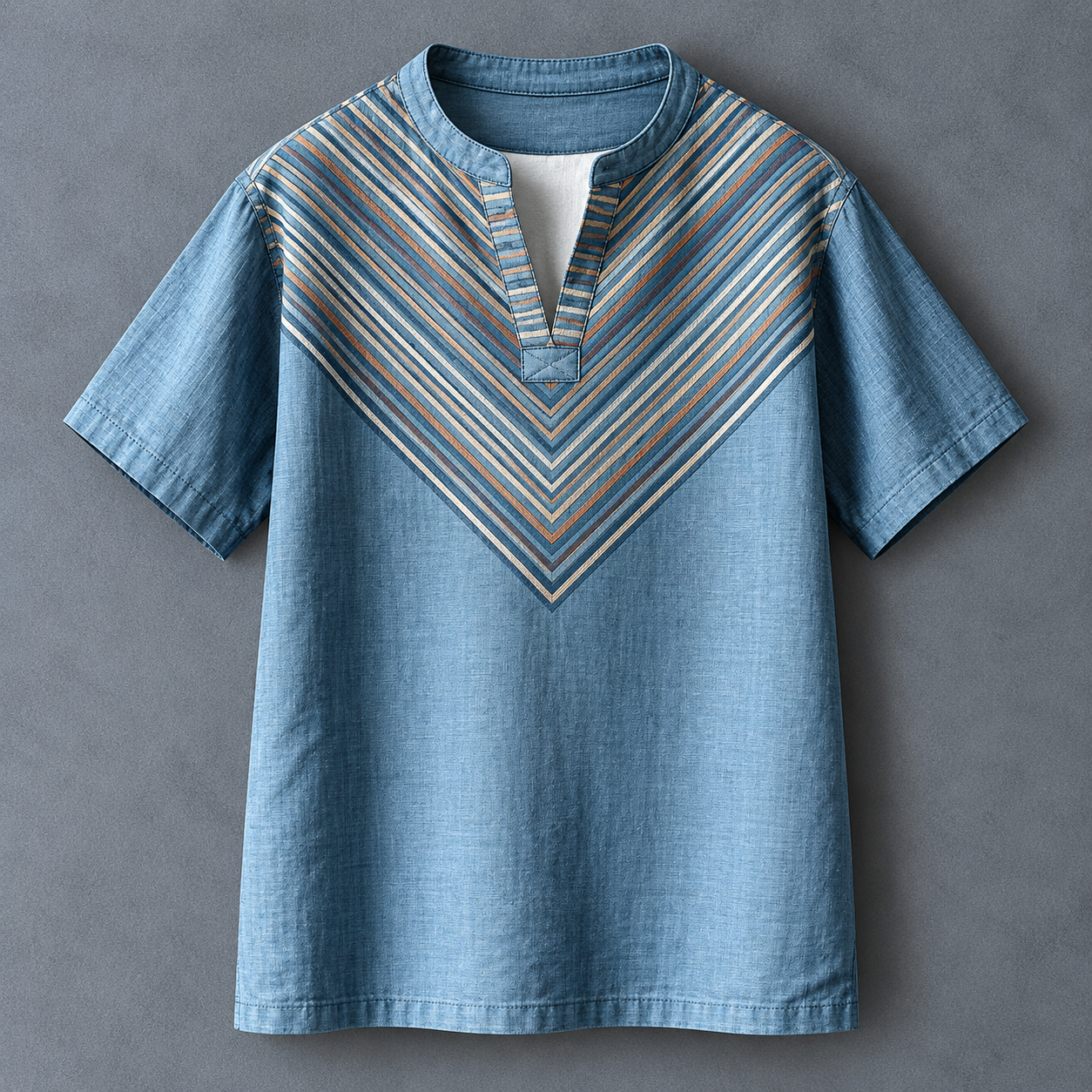 A men's short-sleeve button-up shirt in light blue denim-like fabric, featuring a V-shaped chest panel with diagonal stripes in beige, brown, and blue, and a split neckline.