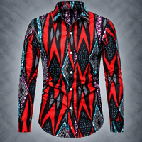 A men's long-sleeve button-up shirt with a bold geometric pattern in red, black, teal, purple, and white, displayed on a gray textured background.