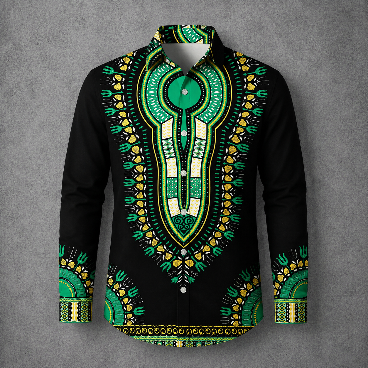 A long-sleeve button-up shirt with a black base and an intricate green, yellow, and white dashiki-style print, displayed on a gray textured background.
