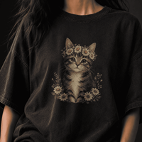 Black t-shirt with a cat design wearing a flower crown on a dark background