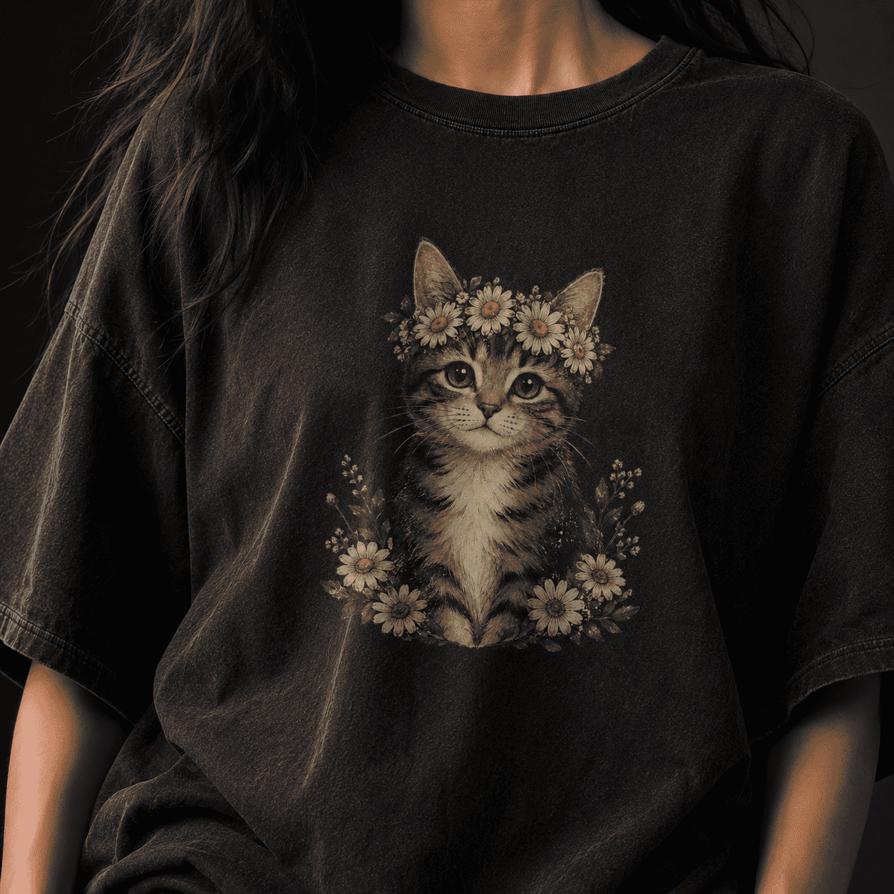 Black t-shirt with a cat design wearing a flower crown on a dark background