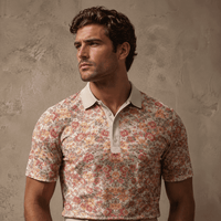 Man wearing a floral patterned shirt against a textured wall.