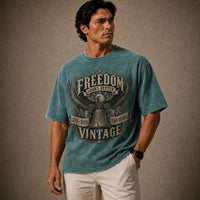Man wearing a blue t-shirt with a graphic design on a brown background