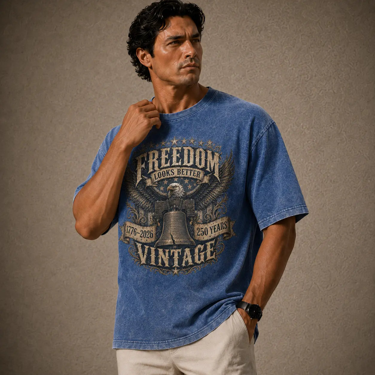 Man wearing a blue t-shirt with 'Freedom Vintage' design on a brown background