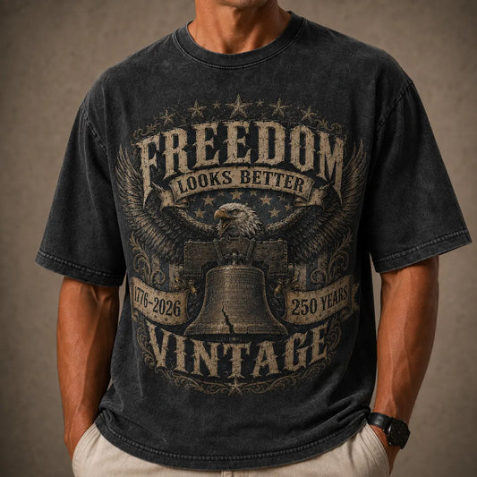 Person wearing a black t-shirt with 'Freedom Looks Better Vintage' design featuring an eagle and bell.