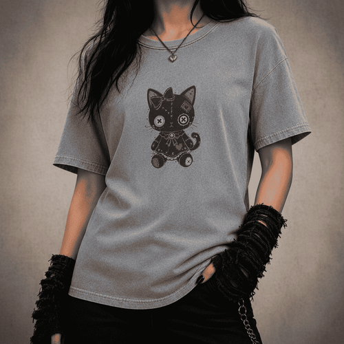 Person wearing a gray t-shirt with a black cat graphic on a dark background