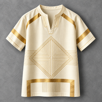 A cream-colored short-sleeve tunic top with gold geometric patterns, displayed flat against a textured gray background.
