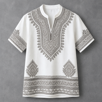 A white short-sleeve tunic top with detailed black geometric and tribal-style embroidery, featuring a split neckline and decorative patterns on the chest, sleeves, and hem, displayed against a textured gray background.
