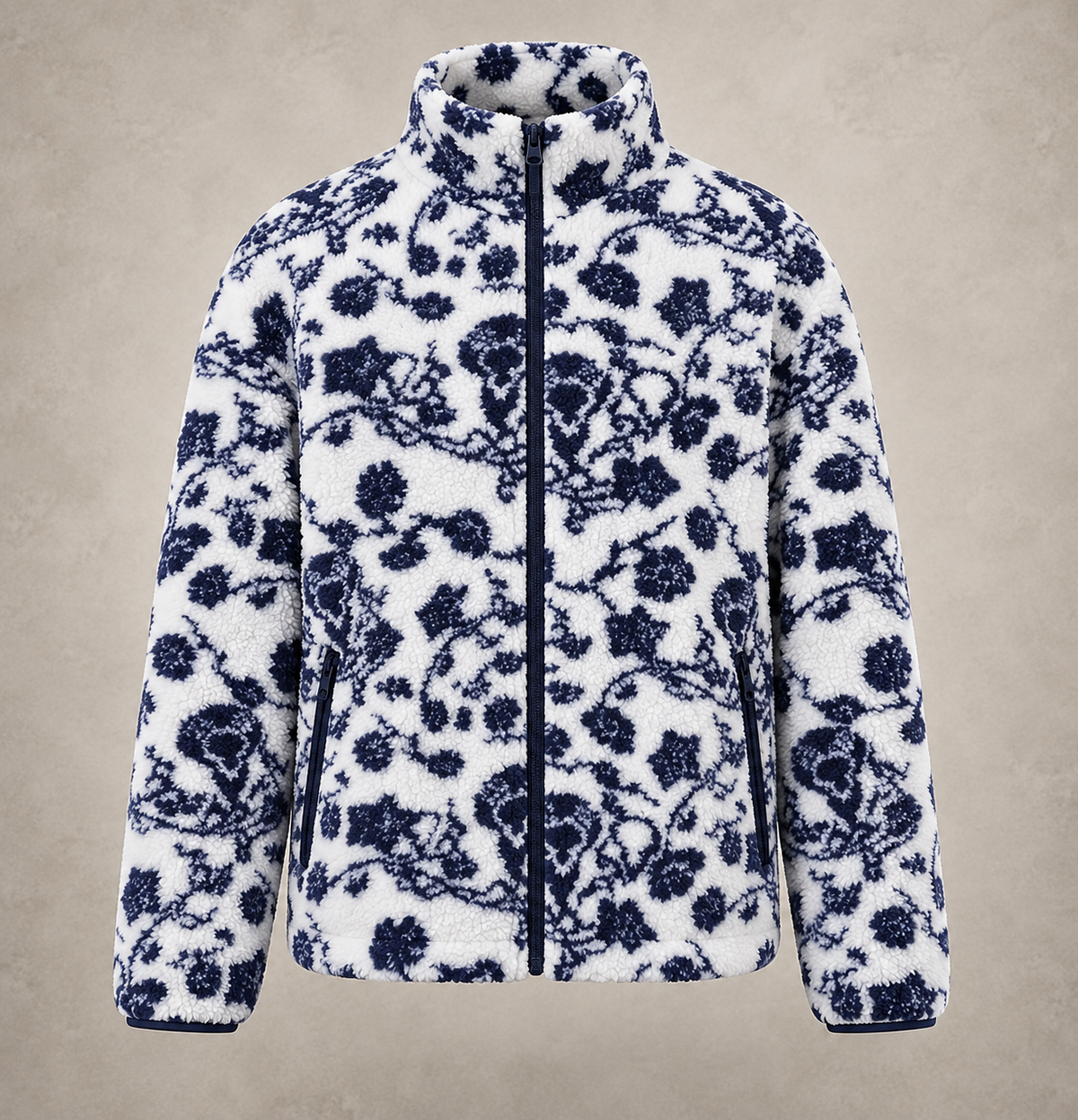 A white sherpa fleece jacket with a navy blue floral and vine pattern, featuring a full-zip front and a high stand-up collar, shown against a textured beige background.