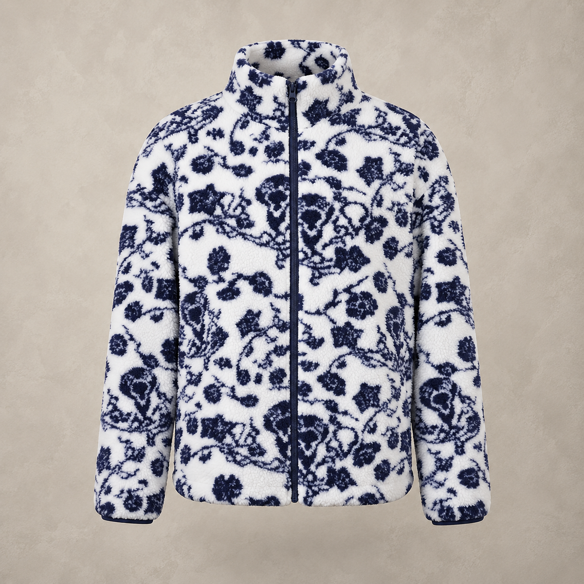 A white fleece zip-up jacket featuring a navy blue floral and branch pattern, displayed against a neutral textured beige background.