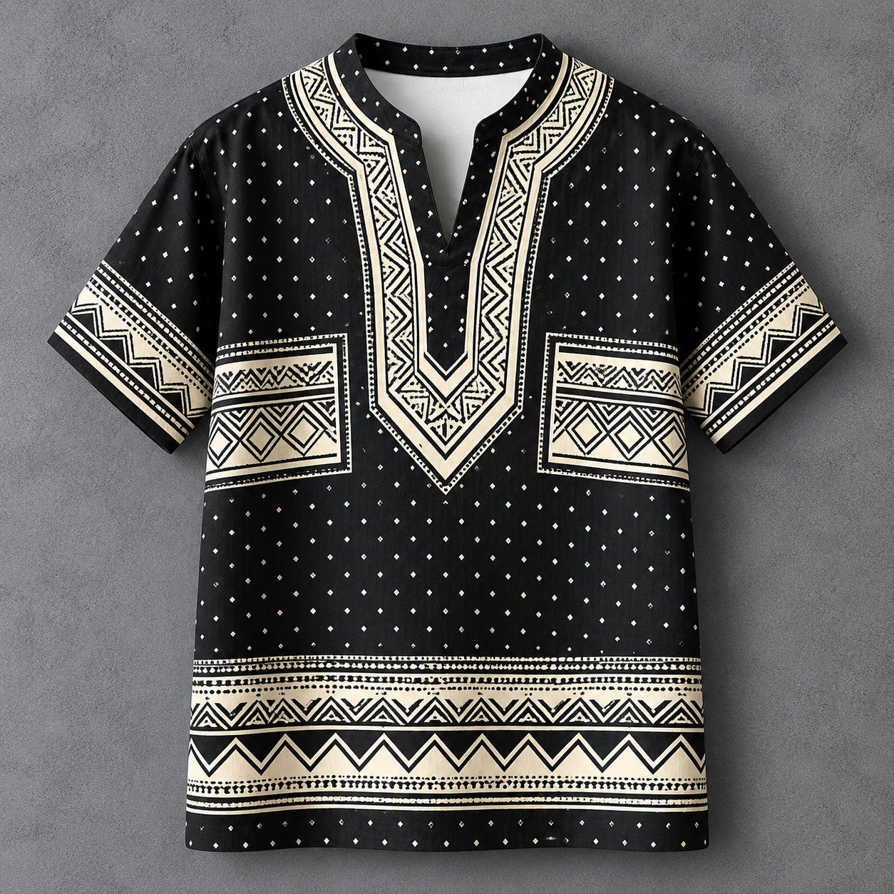 A men's short-sleeve t-shirt with a black base and cream-colored geometric patterns, including a V-neckline, chest pockets, and a horizontal band near the hem, displayed flat against a textured gray background.
