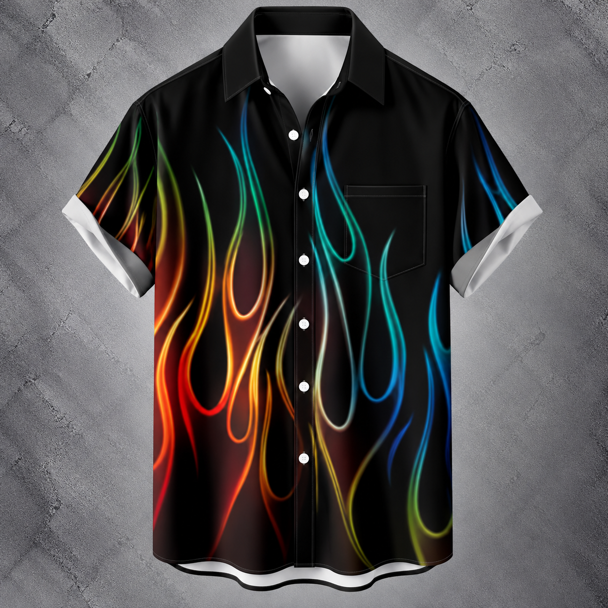 A short-sleeve button-up shirt with a black base and a vibrant, multicolored flame pattern in red, orange, yellow, green, and blue, displayed against a textured gray background.