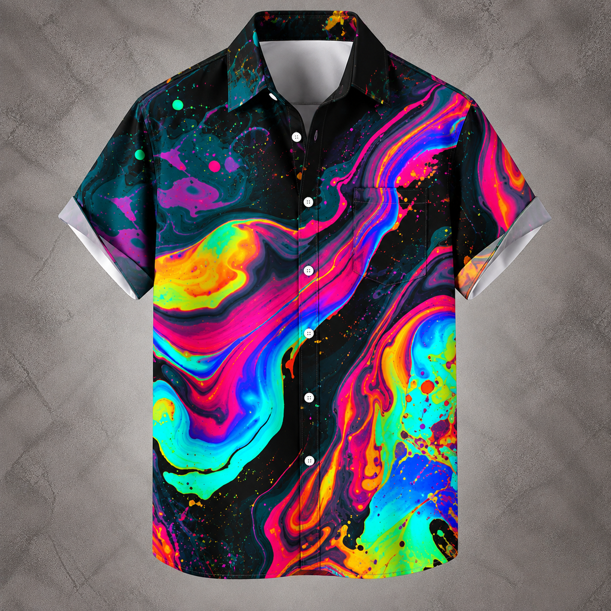 A short-sleeve button-up camp shirt with a vibrant, multicolored psychedelic fluid marble print on a black background, displayed against a textured gray wall.