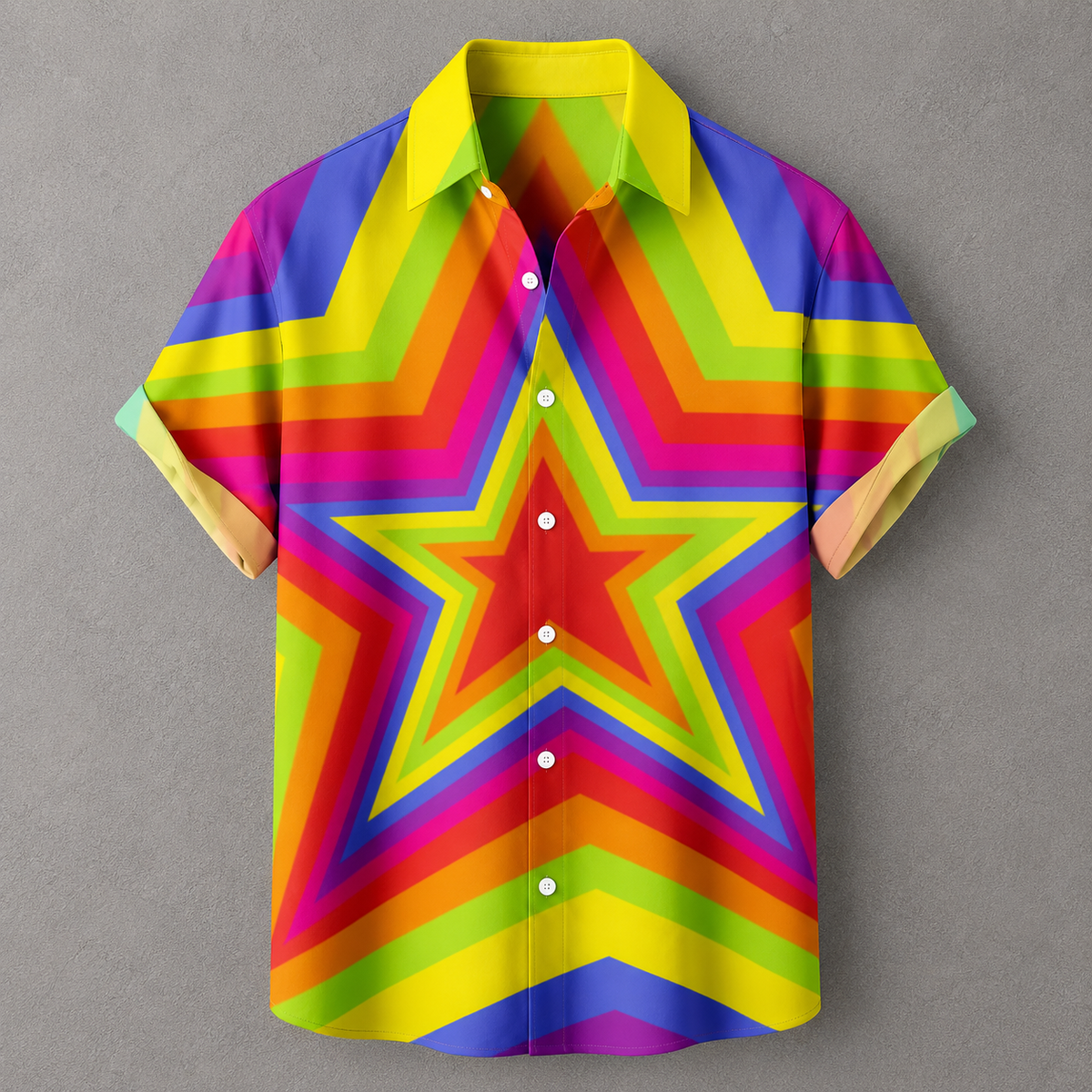 A short-sleeve button-up shirt with a bold rainbow star pattern, displayed against a neutral gray background.