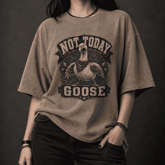 Person wearing a brown t-shirt with 'Not Today Goose' graphic design on a dark background