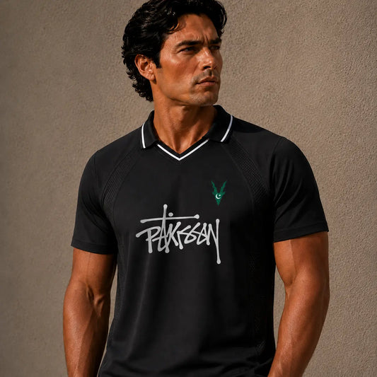 Man wearing a black polo shirt with a logo on a beige background