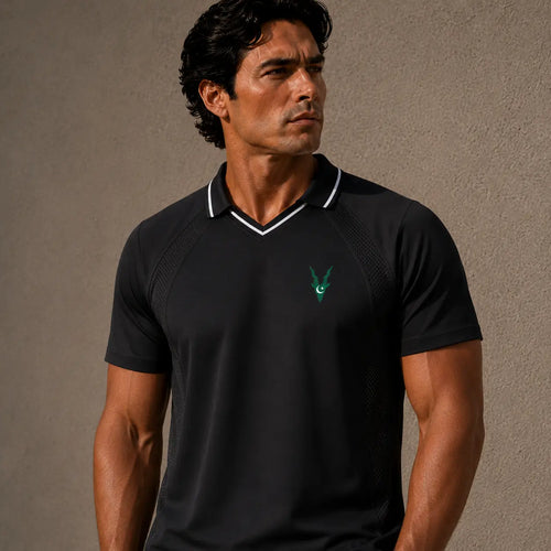 Man wearing a black polo shirt with a green logo on a brown background