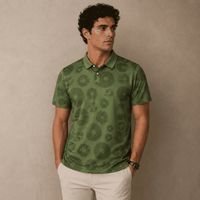 Man wearing a green patterned polo shirt against a beige background