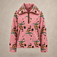 A pink sherpa fleece half-zip pullover jacket featuring an all-over abstract print in teal, olive green, and black, displayed against a neutral beige background.