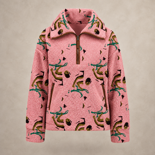 A pink sherpa fleece half-zip pullover jacket featuring an all-over abstract print in teal, olive green, and black, displayed against a neutral beige background.