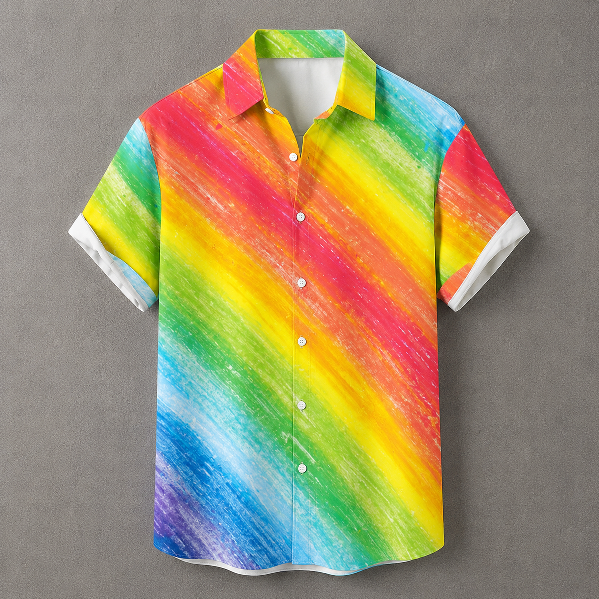A short-sleeve button-up shirt with a vibrant rainbow diagonal stripe pattern, displayed against a neutral gray background.