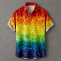 A short-sleeve button-up shirt with a vibrant rainbow watercolor gradient pattern, featuring red, orange, yellow, green, blue, and purple tones, displayed against a textured gray background.