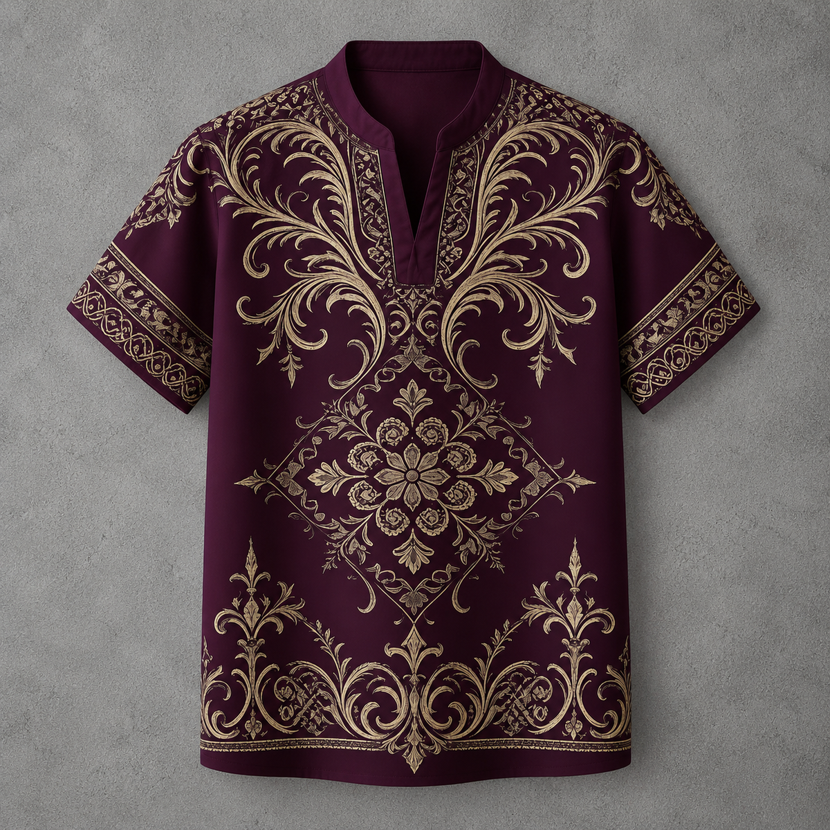 A short-sleeve polo shirt in deep burgundy with an intricate gold baroque-style damask pattern, laid flat against a textured gray background.