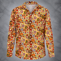 A long-sleeve button-up shirt with a vibrant retro 1970s-style circular target pattern in orange, yellow, red, black, and white, displayed on a gray textured background.