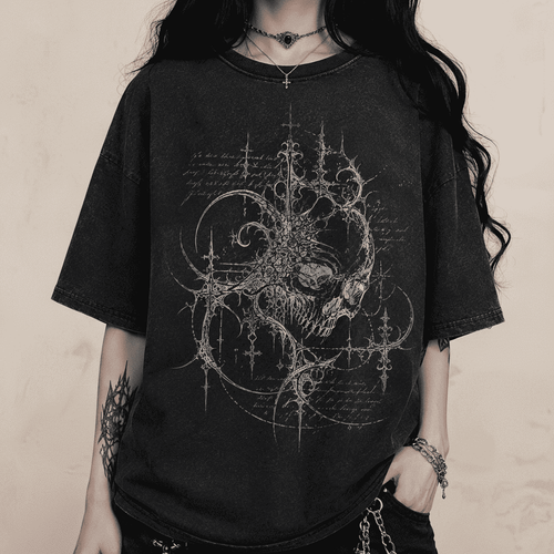 Person wearing a black t-shirt with intricate design on a dark background