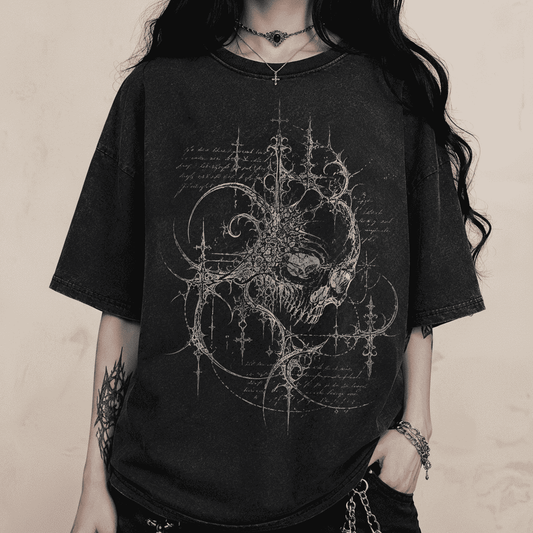 Person wearing a black t-shirt with intricate design on a dark background