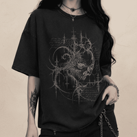 Person wearing a black t-shirt with intricate design on a dark background