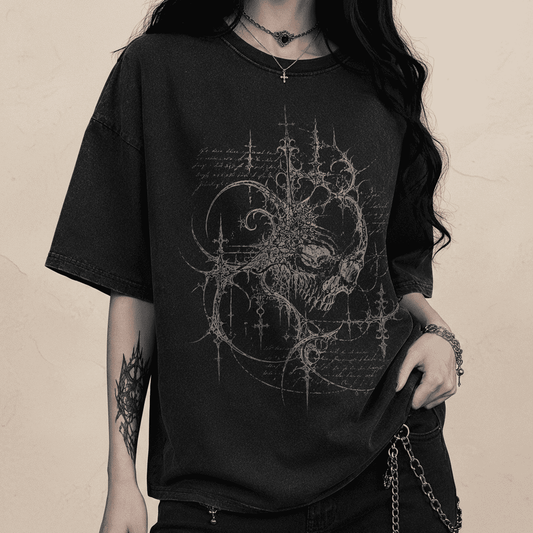 Person wearing a black t-shirt with intricate design on a dark background