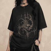 Person wearing a black t-shirt with a detailed design on a dark background