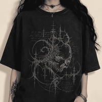 Person wearing a black t-shirt with intricate design on a dark background