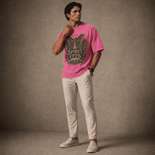 Man wearing a pink t-shirt with a graphic design and light-colored pants against a gray background