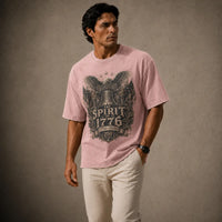Man wearing a pink t-shirt with a graphic design on a brown background