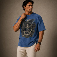 Man wearing a blue t-shirt with a graphic design on a brown background