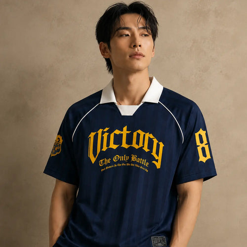 Person wearing a navy blue sports jersey with 'Victory' and number '8' on a beige background