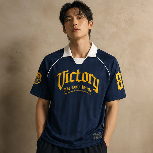 Person wearing a navy blue sports jersey with 'Victory' and number '8' on a beige background