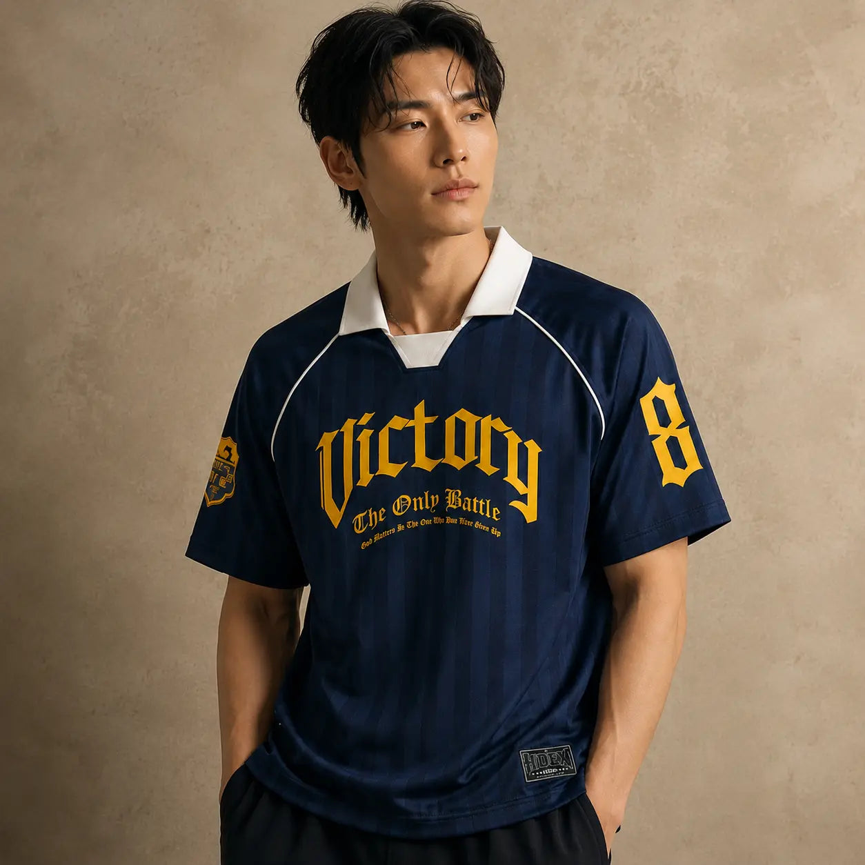 Person wearing a navy blue sports jersey with yellow text and numbers on a beige background