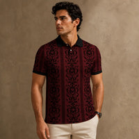 Man wearing a patterned maroon shirt against a beige background